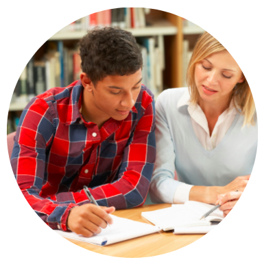 Two teenagers studying at a desk in a library; automaticity in reading and learning RNG International Educational Consultants